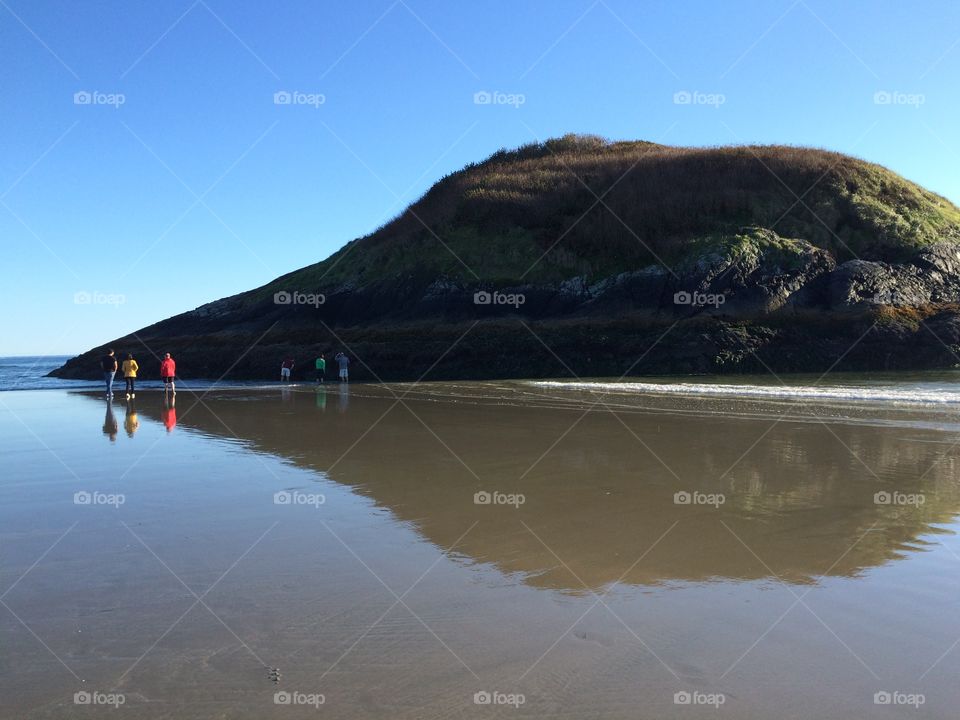 Cliff reflecting on sea