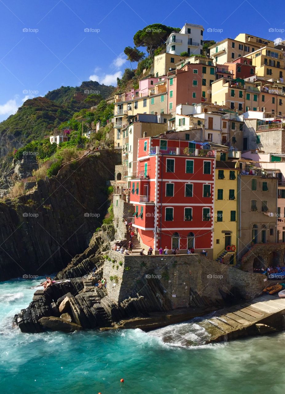 Tourists at a cliff in Riomaggiore Italy