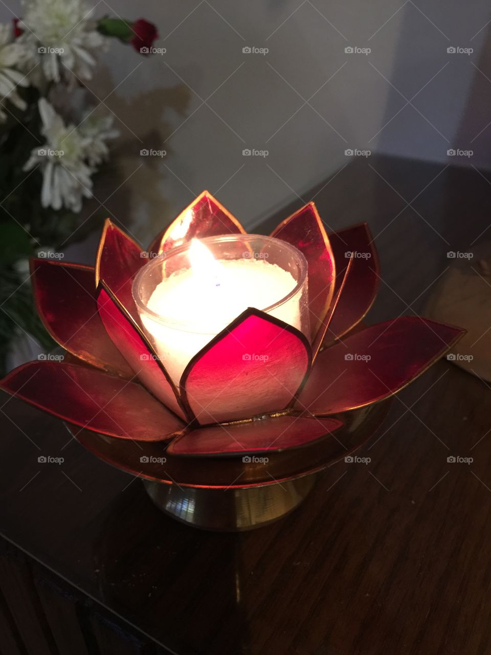 Candle in red flower holder