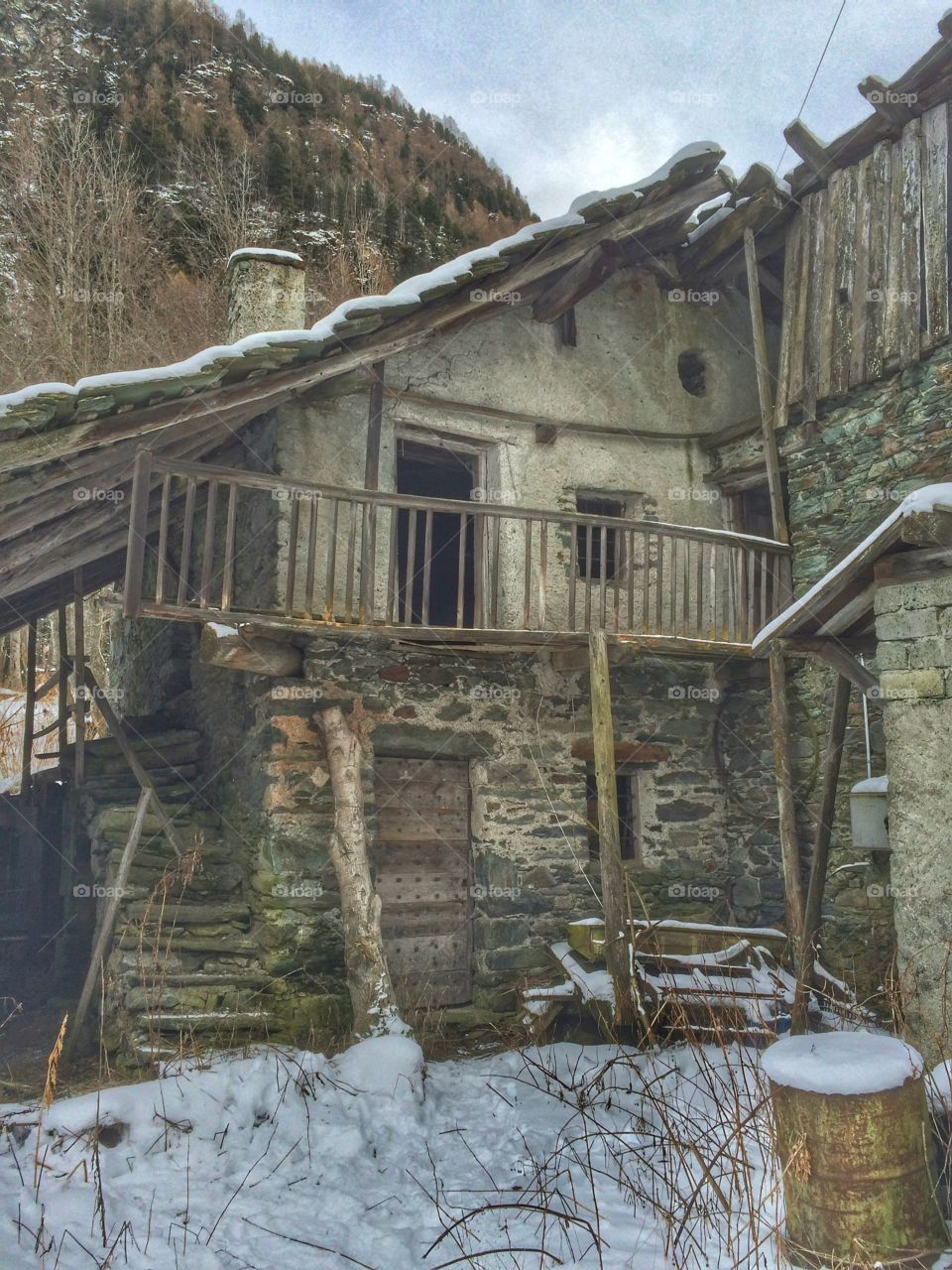 Old barn with snow in winter time 