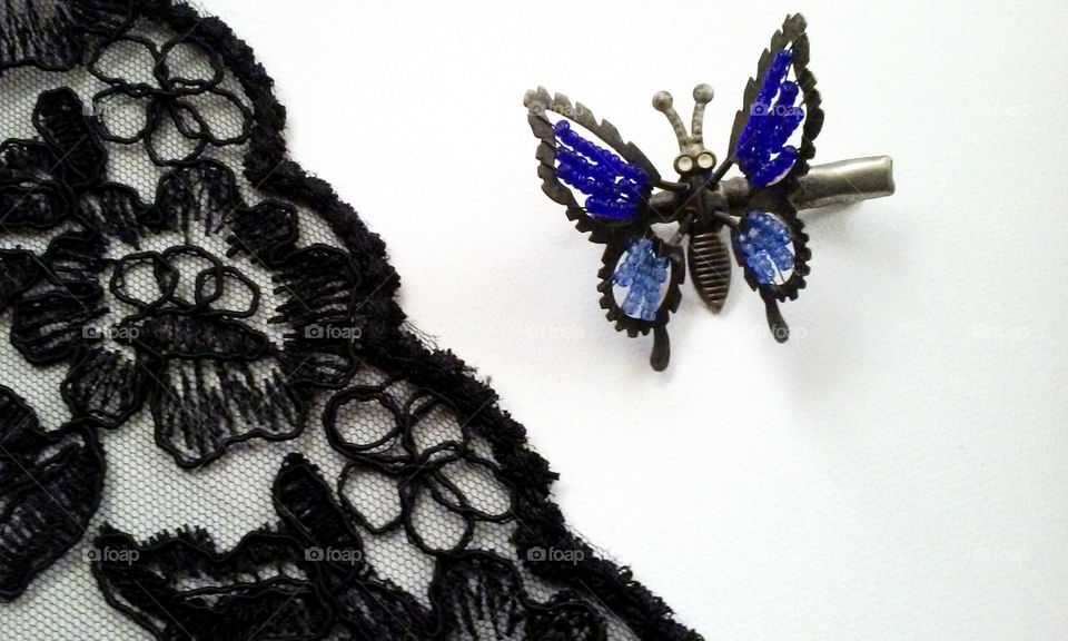 Net lace and butterfly clip on white background