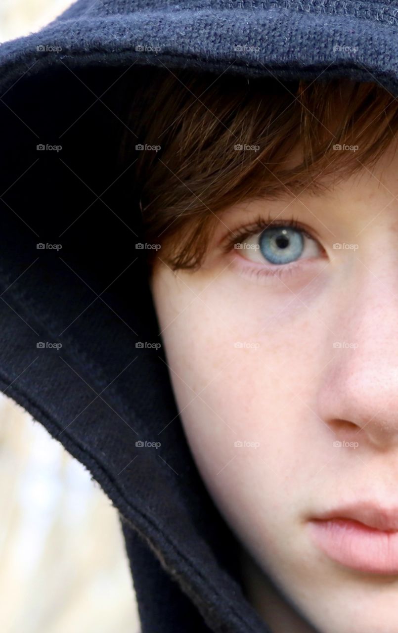 Closeup of half of a blue eyed boy