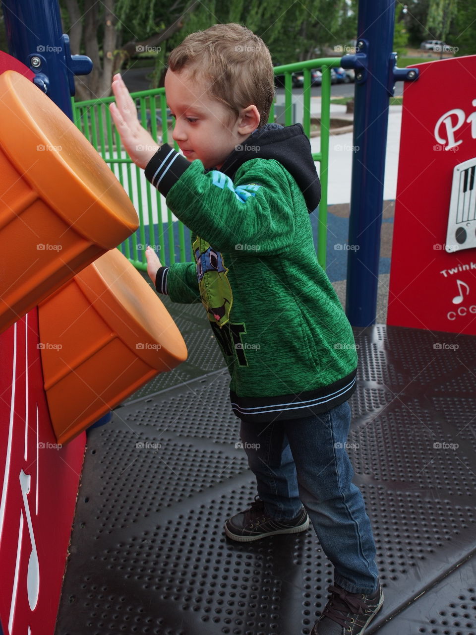 A young boy plays the drums on a children’s park in Redmond in Central Oregon. 