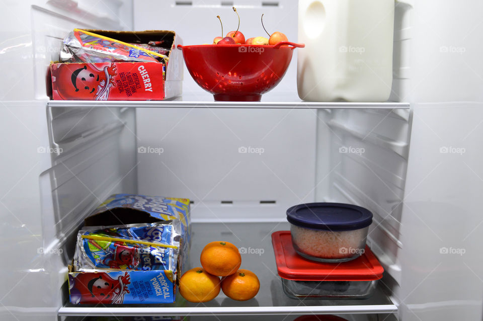 Drink pouch cases shown in an open refrigerator with fruit