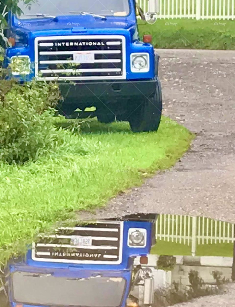 Reflection of a truck in a water puddle 