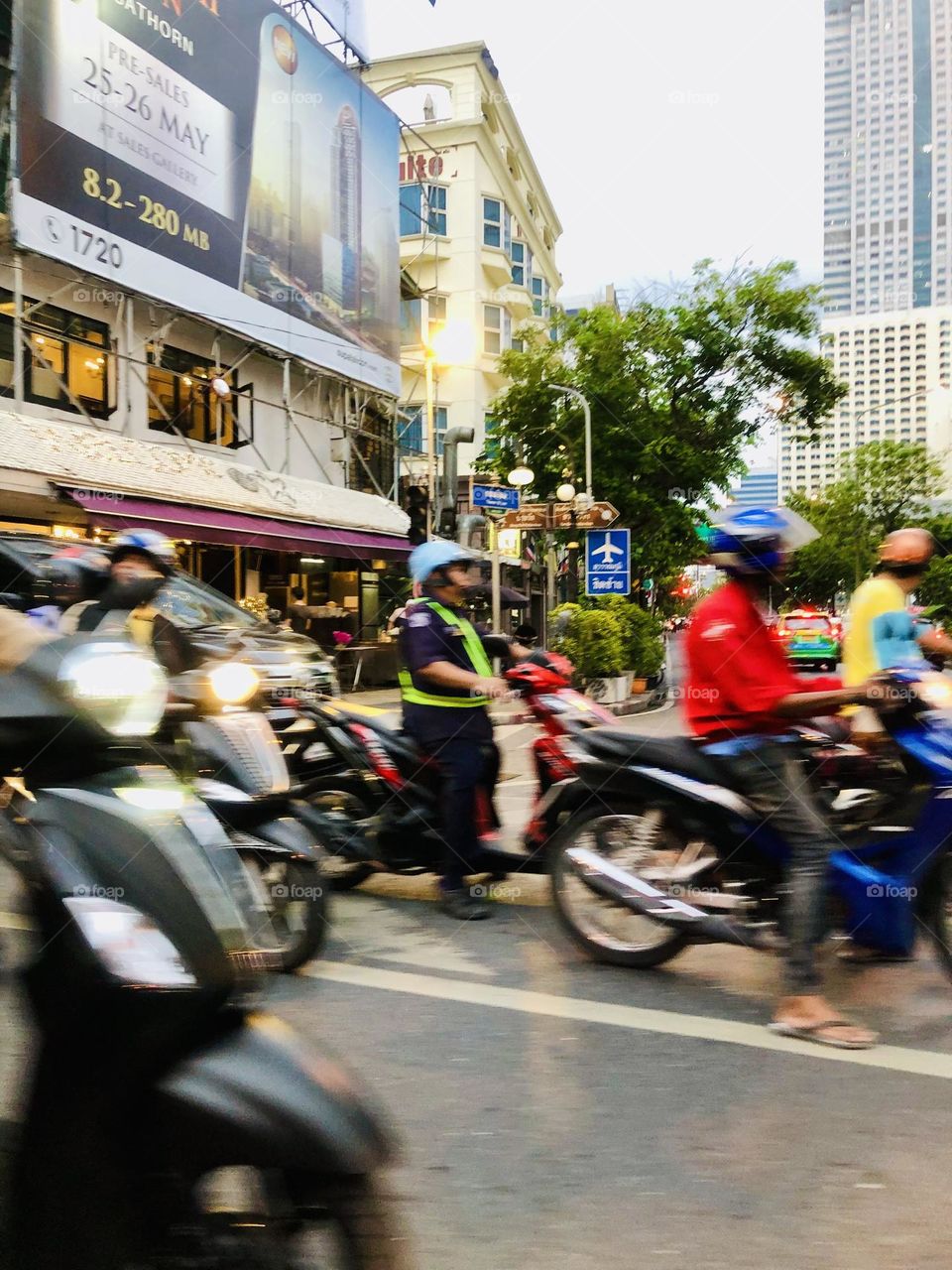 Workers commuting by motorcycle in Bangkok 