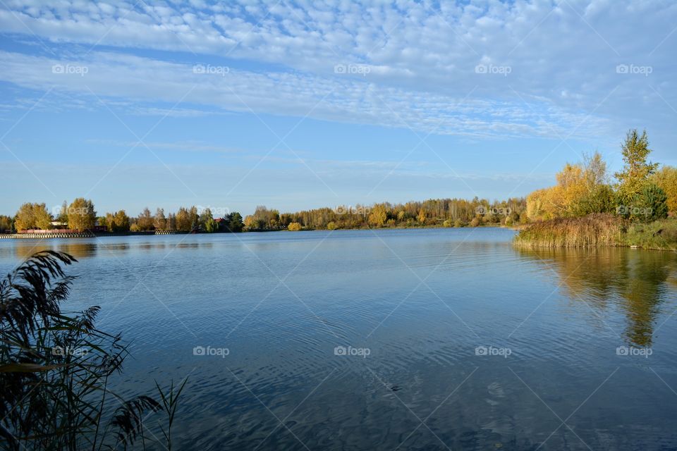 beautiful landscape lake and trees blue sky background autumn time