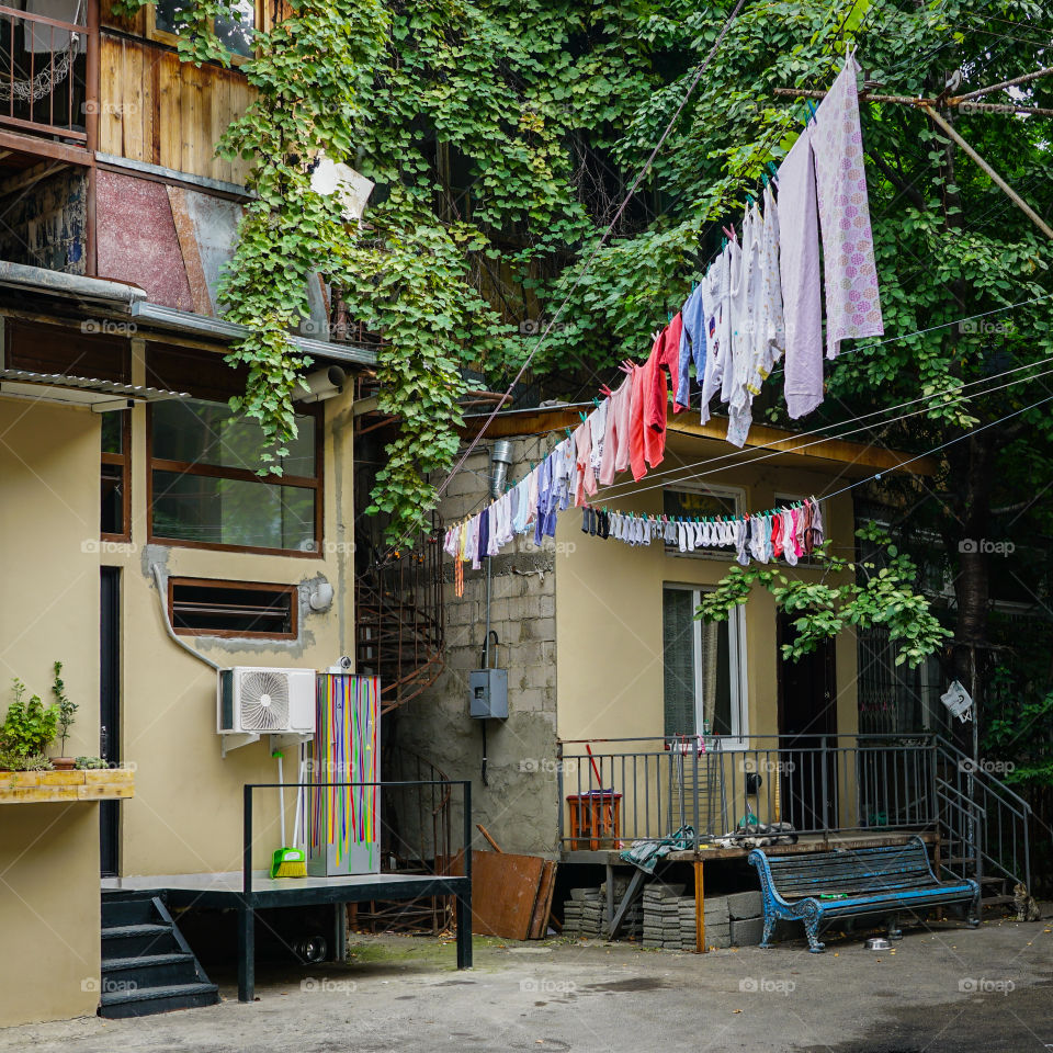 view of the outside of the household, clothes dries on ropes on clothespins