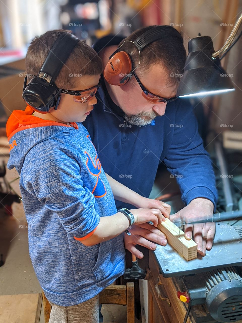 father and son doing wood working together