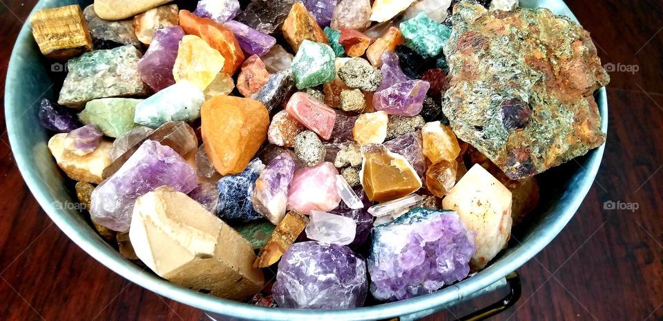 bucket full of colorful gemstones
