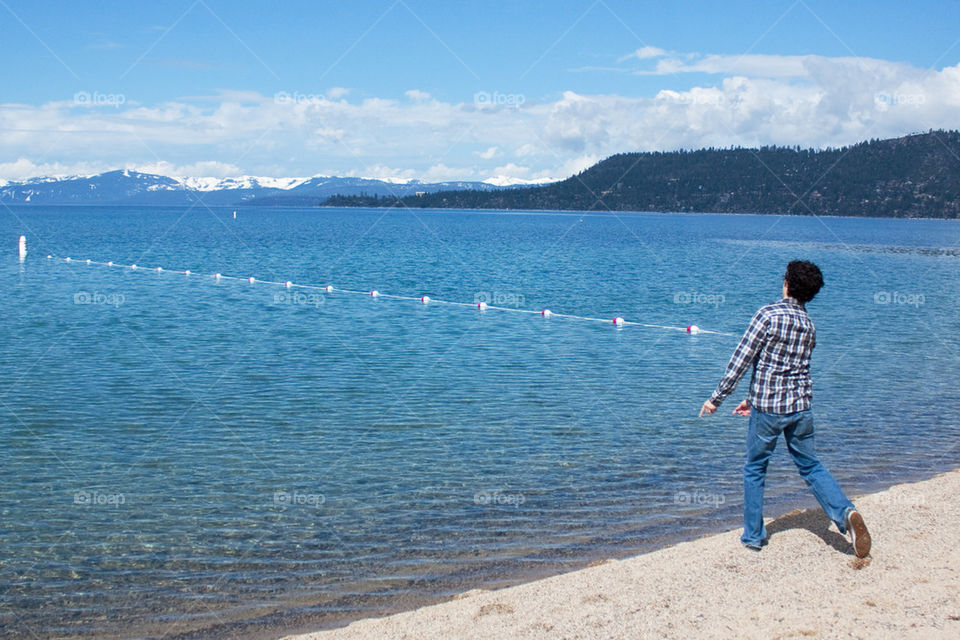 Man skipping rocks