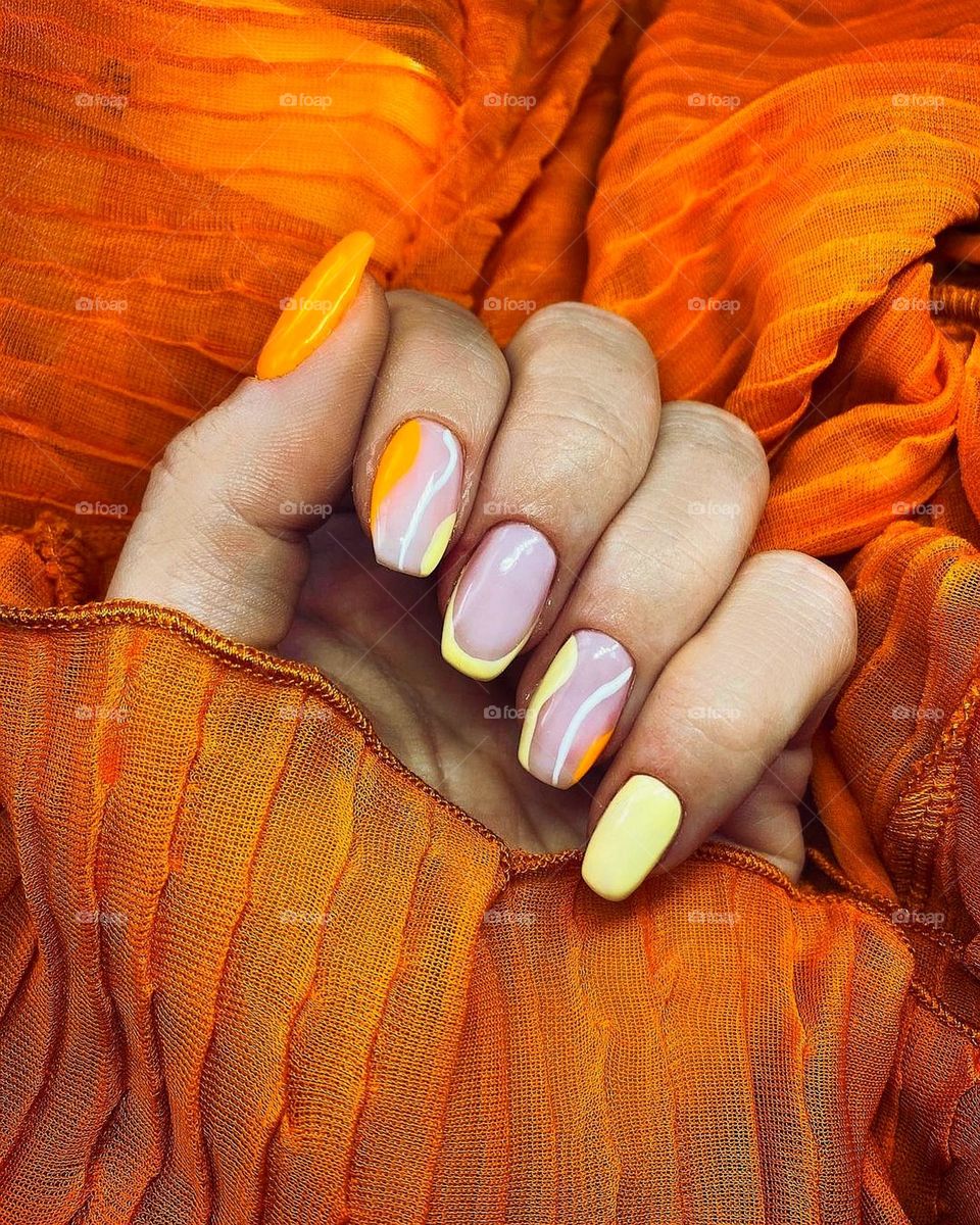Bright color manicure for fun days and nights with popping matching orange background