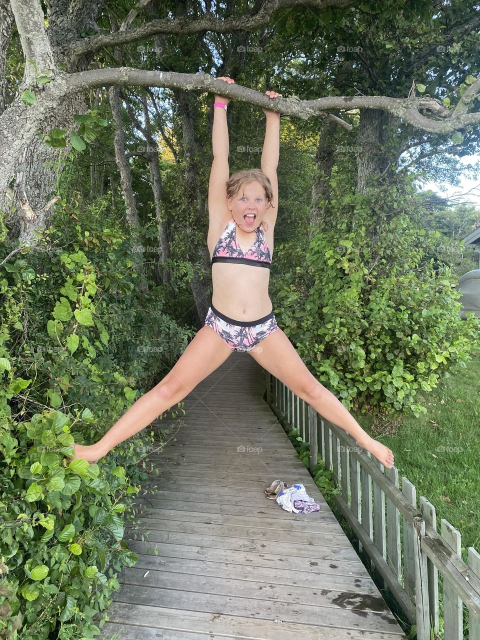 child hanging from a tree