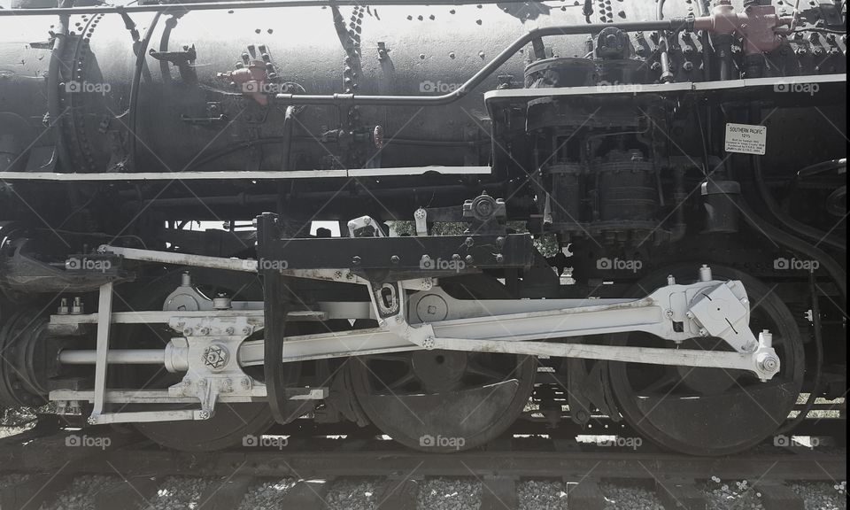 a side view of a retired steam engine in a history park.