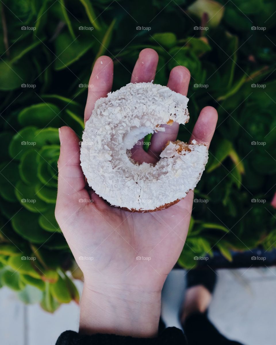 Hand holding doughnut. 