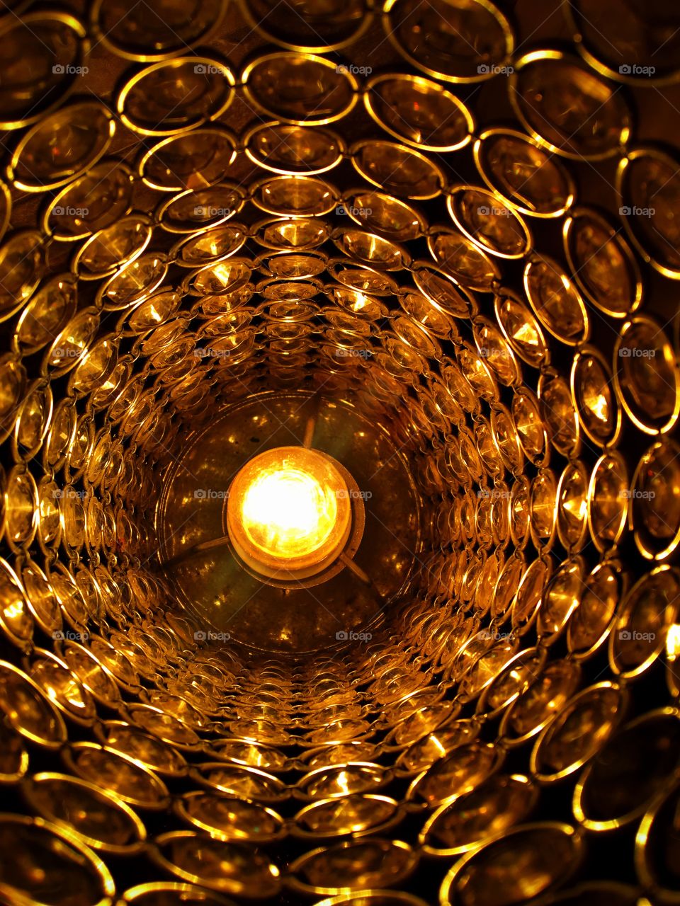 Close up light bulb in lamp. Golden abstract effect