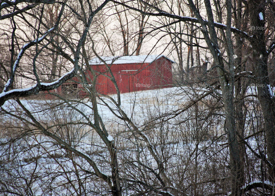 Red barn in white snow freezing