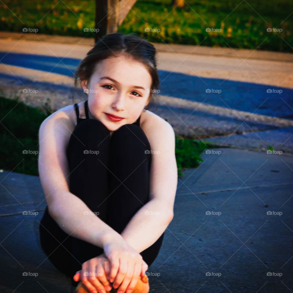 girl sitting in driveway