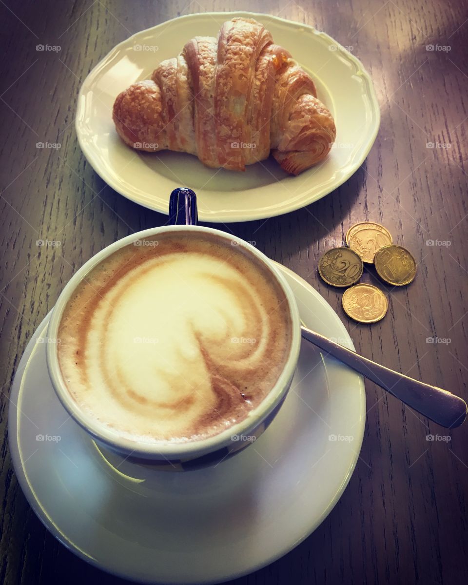 Italian breakfast at the bar with euro coins