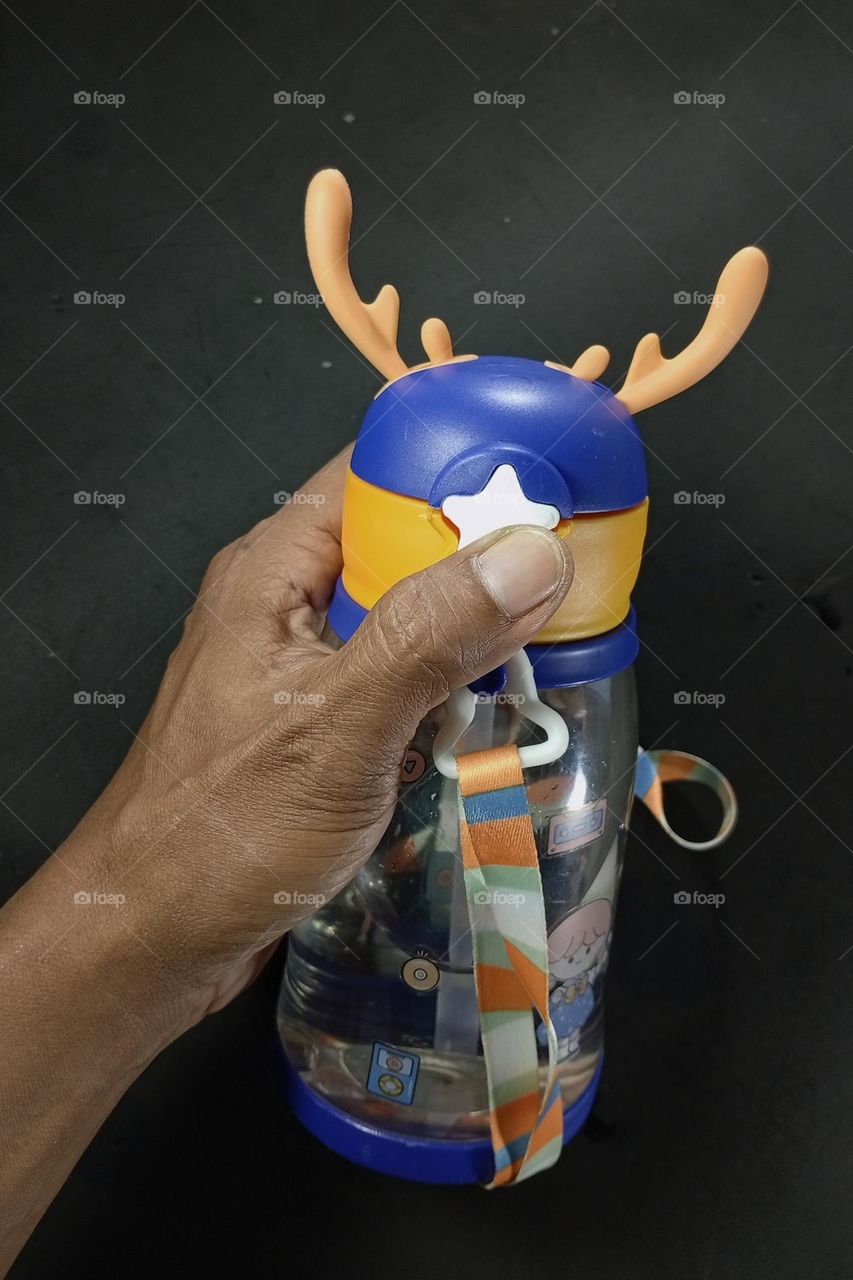 hand holding cute water container