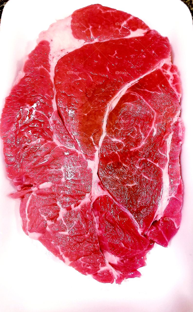 A piece of raw meat (beef)