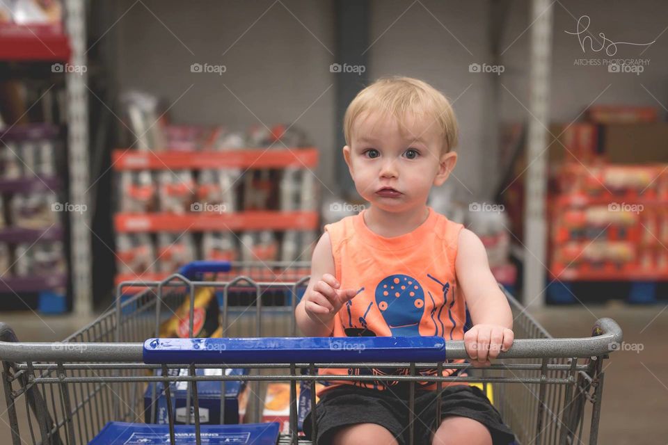 Boy in shopping cart 