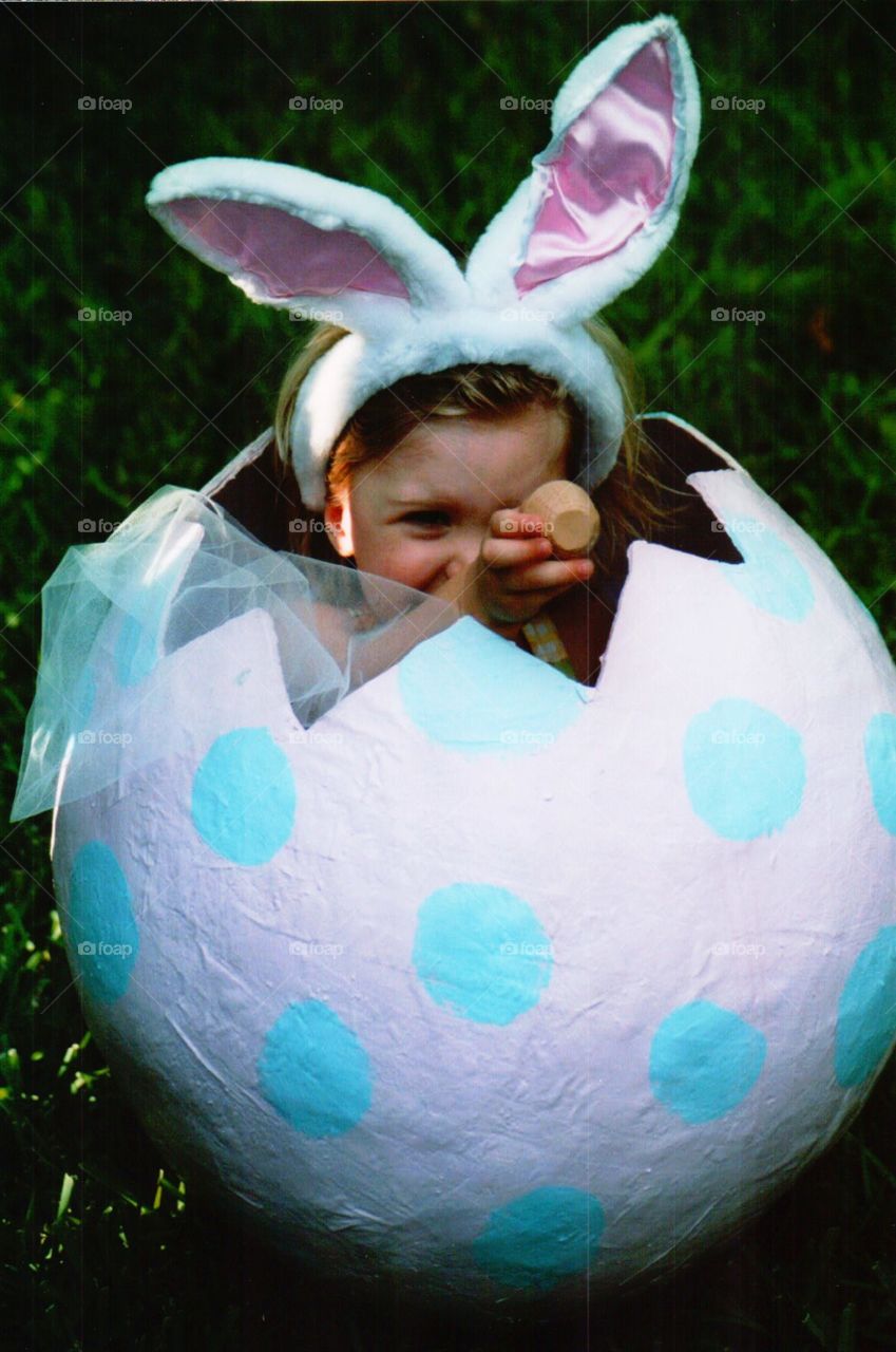 Little girl in an Easter egg