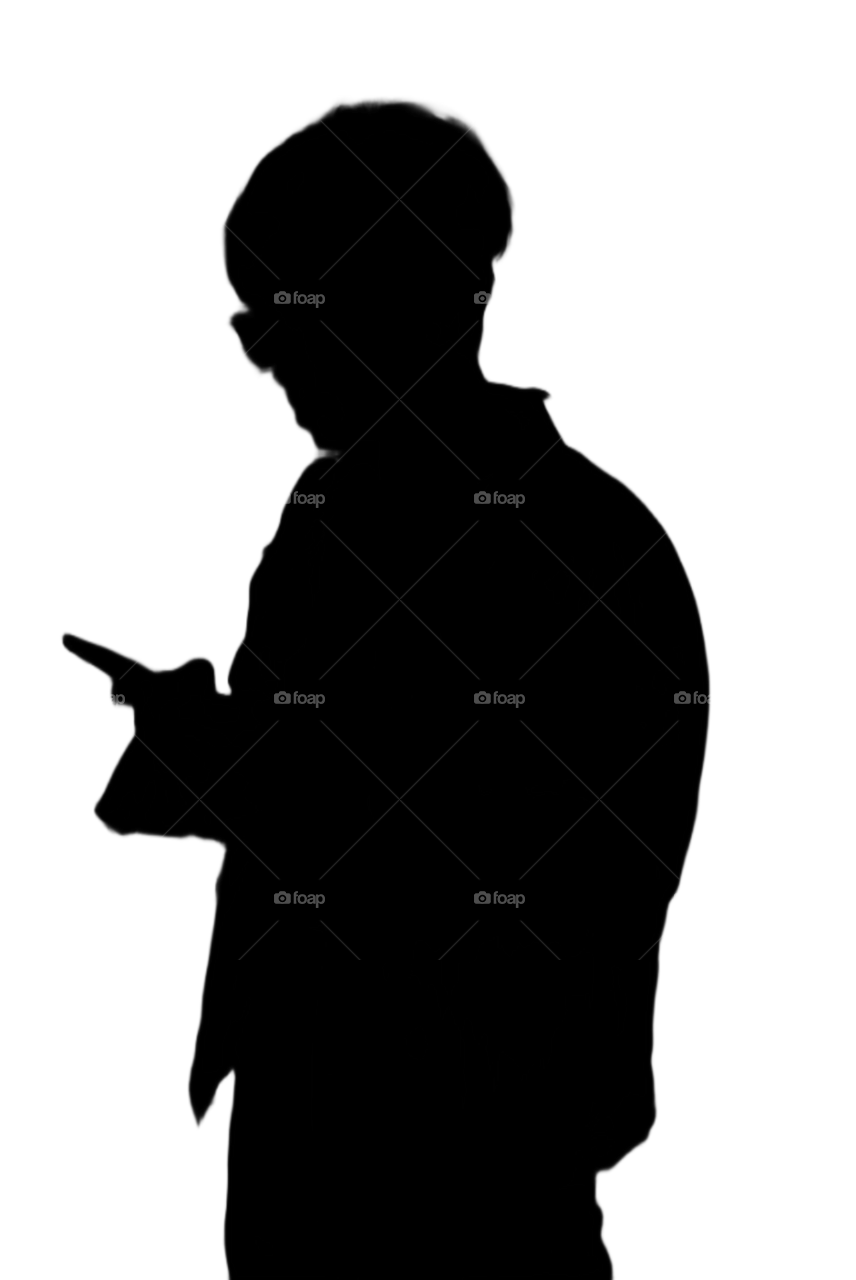 Silhouette photo of a person holding a cell phone