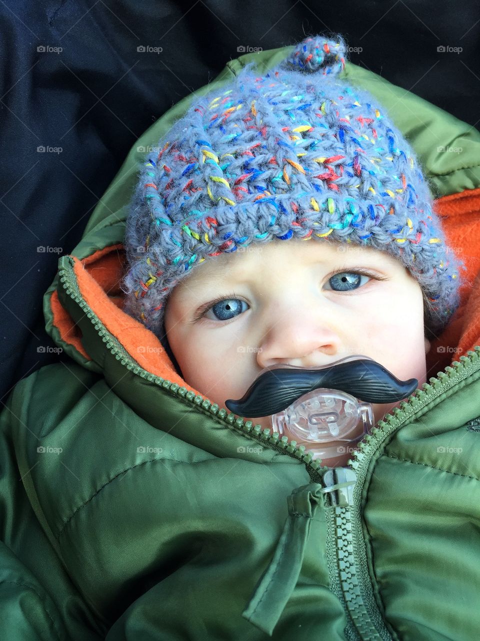Cute baby boy with mustache pacifier 
