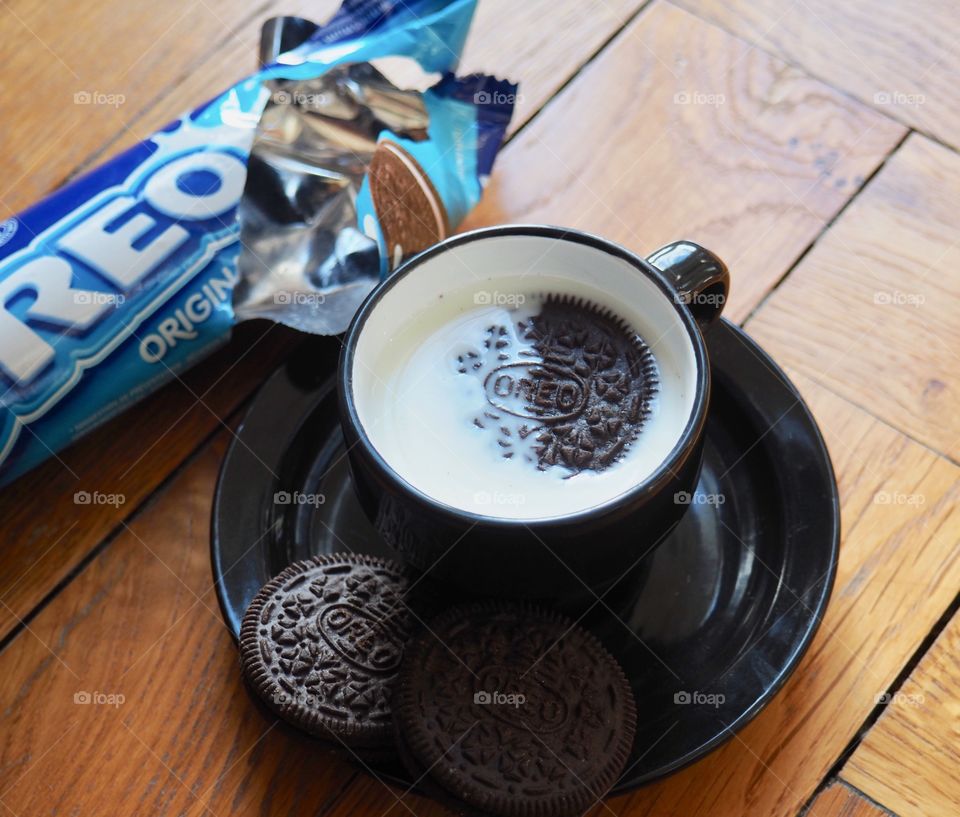 Oreo cookies with cup of milk.