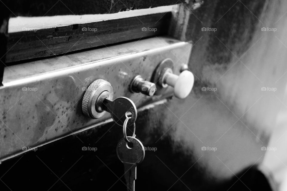 Keys in a very old car ignition In black and white