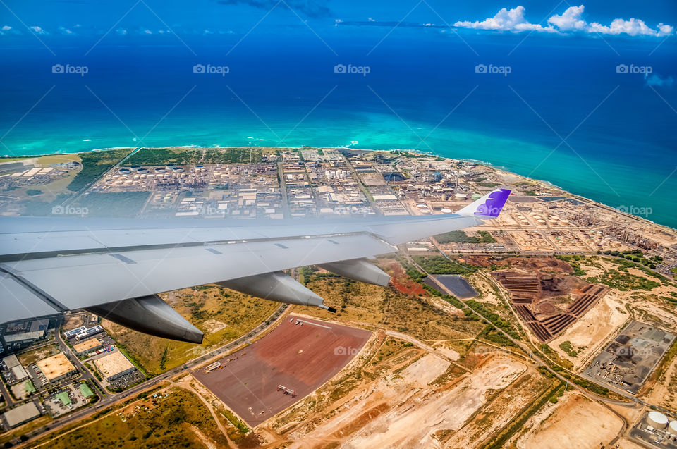 Approaching Honolulu International Airport. The plane banks slightly to align itself for the final descend.