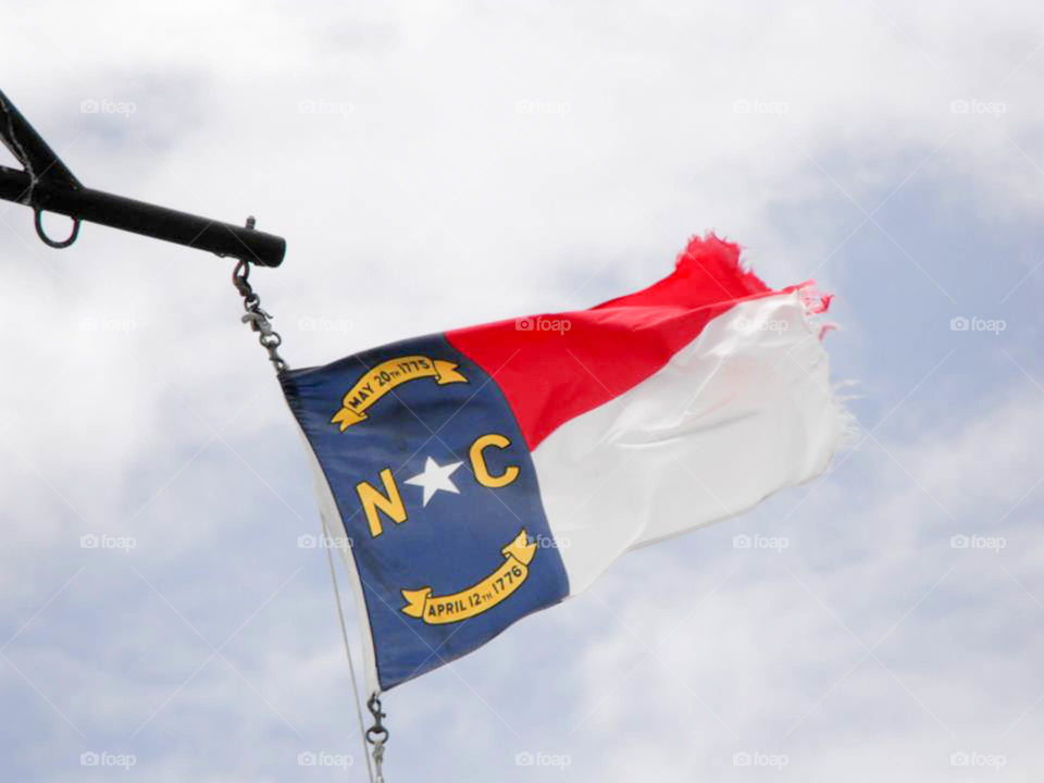 North Carolina flag. North Carolina flag flies high above the ferry on the way to Ocracoke Island