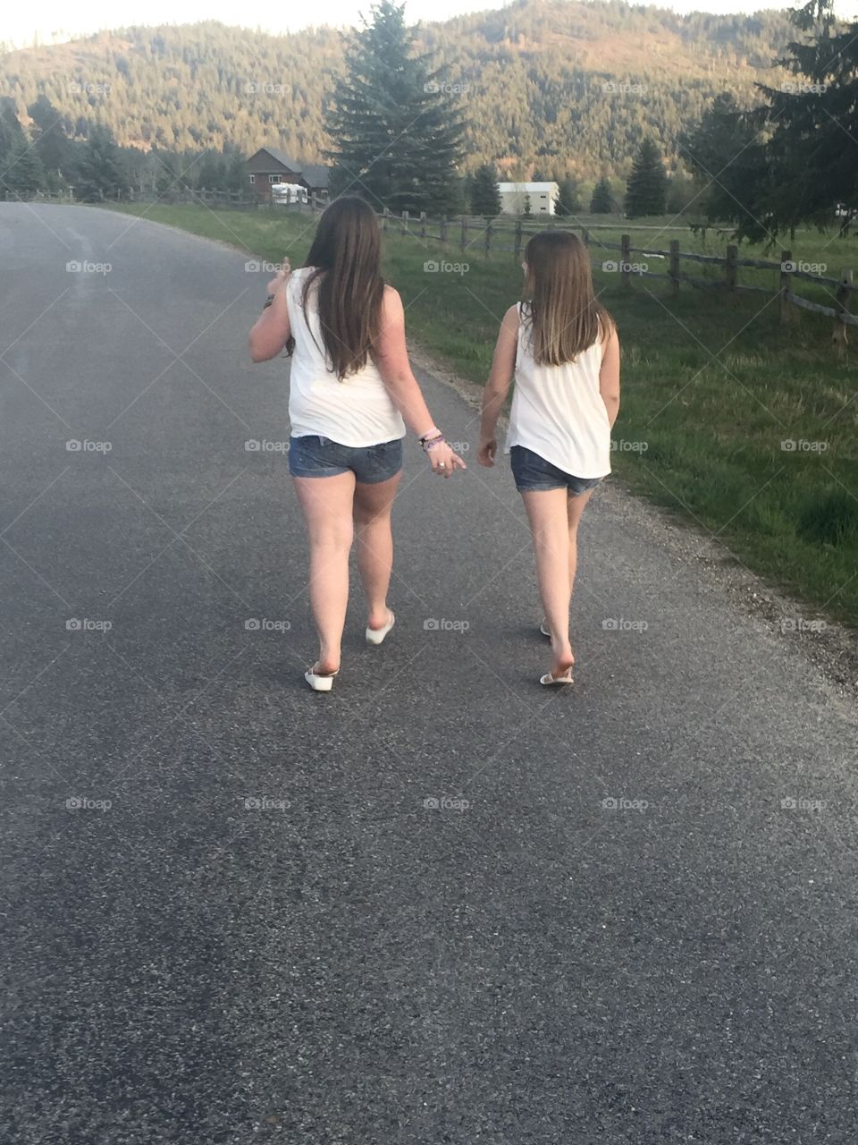 Girls Take a Peaceful Walk Down A Country Road 