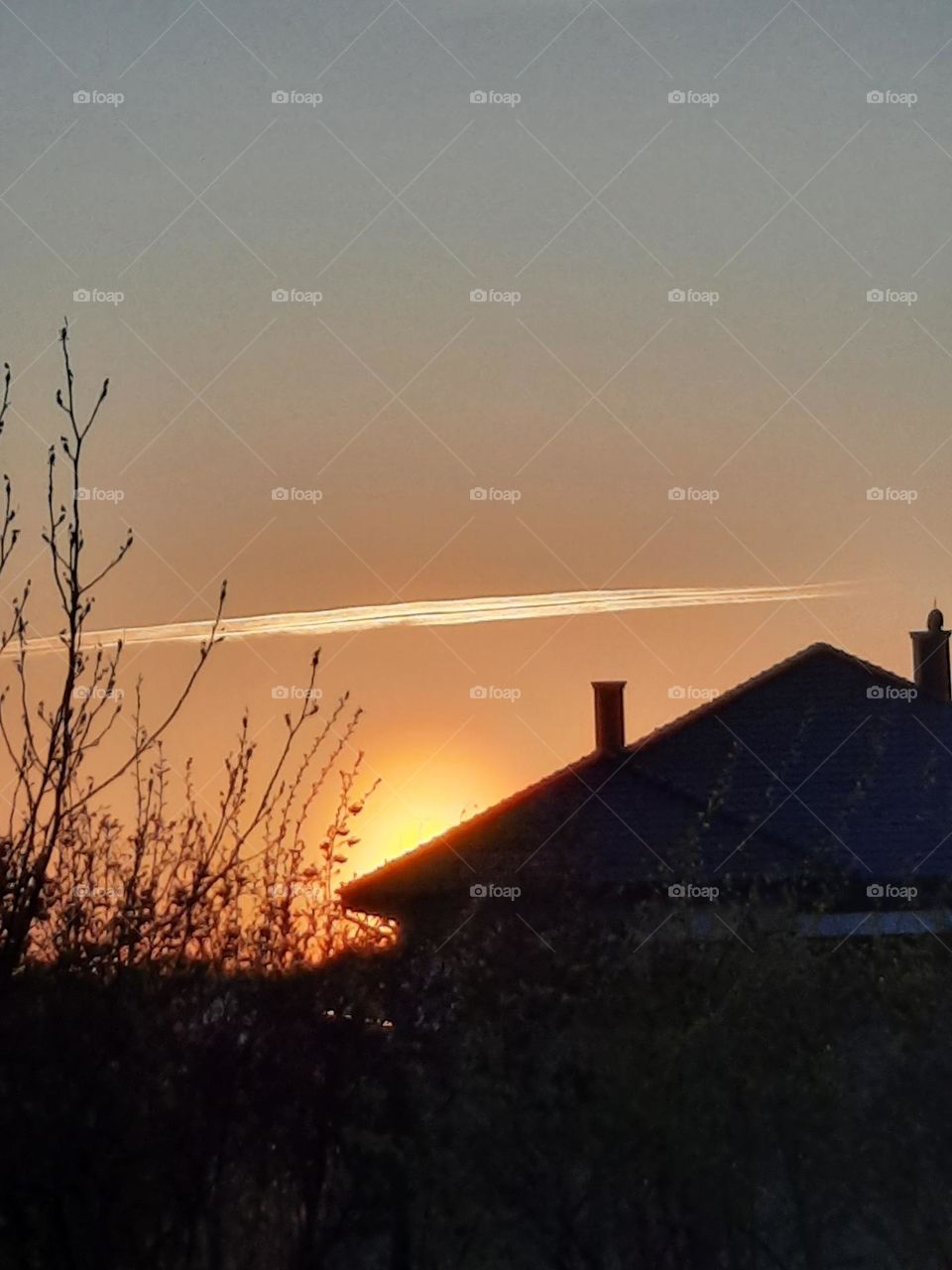 sunrise with airplane trace in the sky