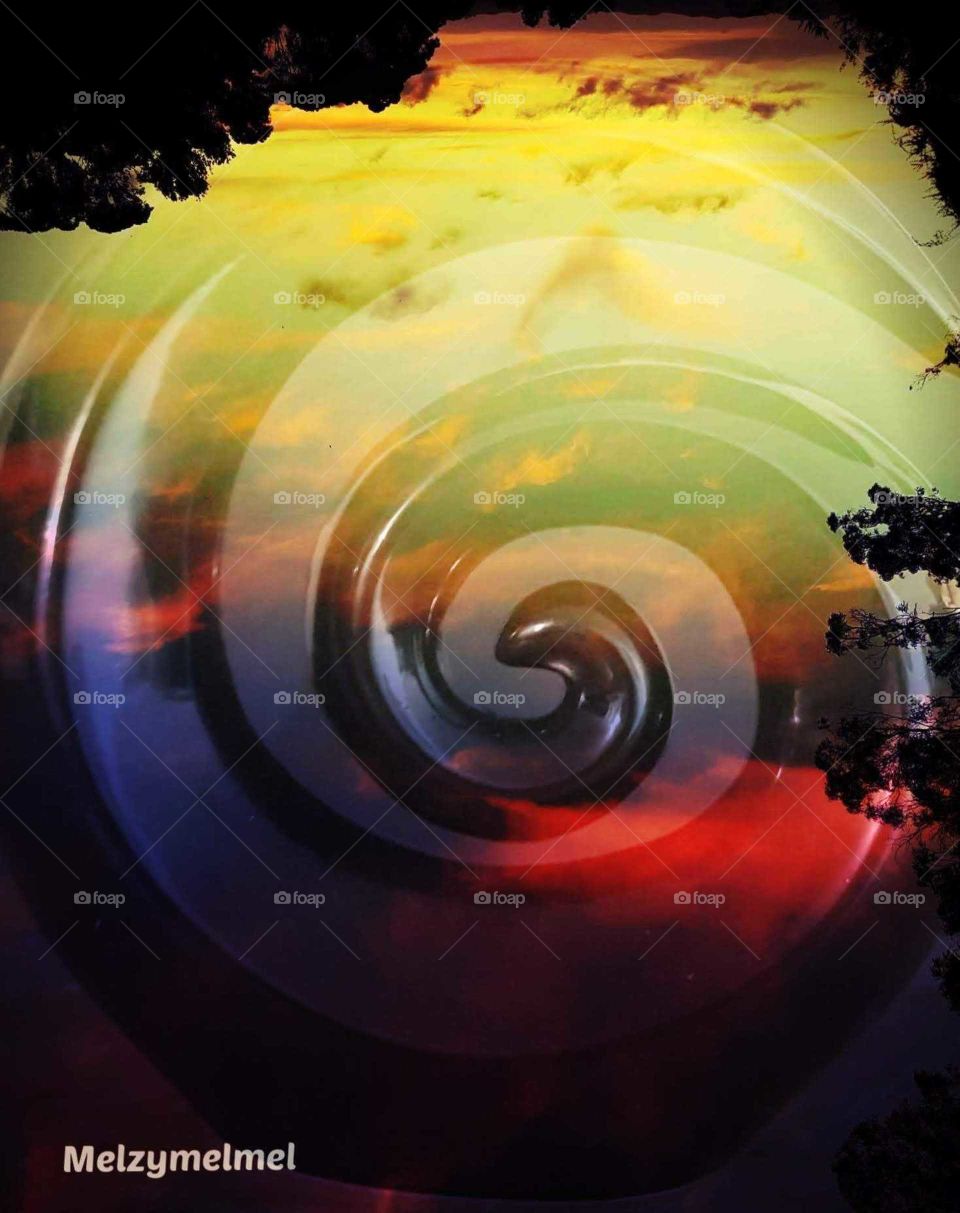 My creation of an upside down vibrant colored sunset and a black koru (Spiral) inserted into the photo.