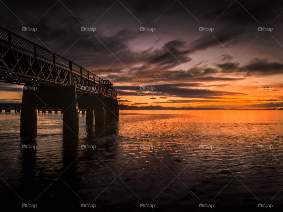 bridge and water at sunset