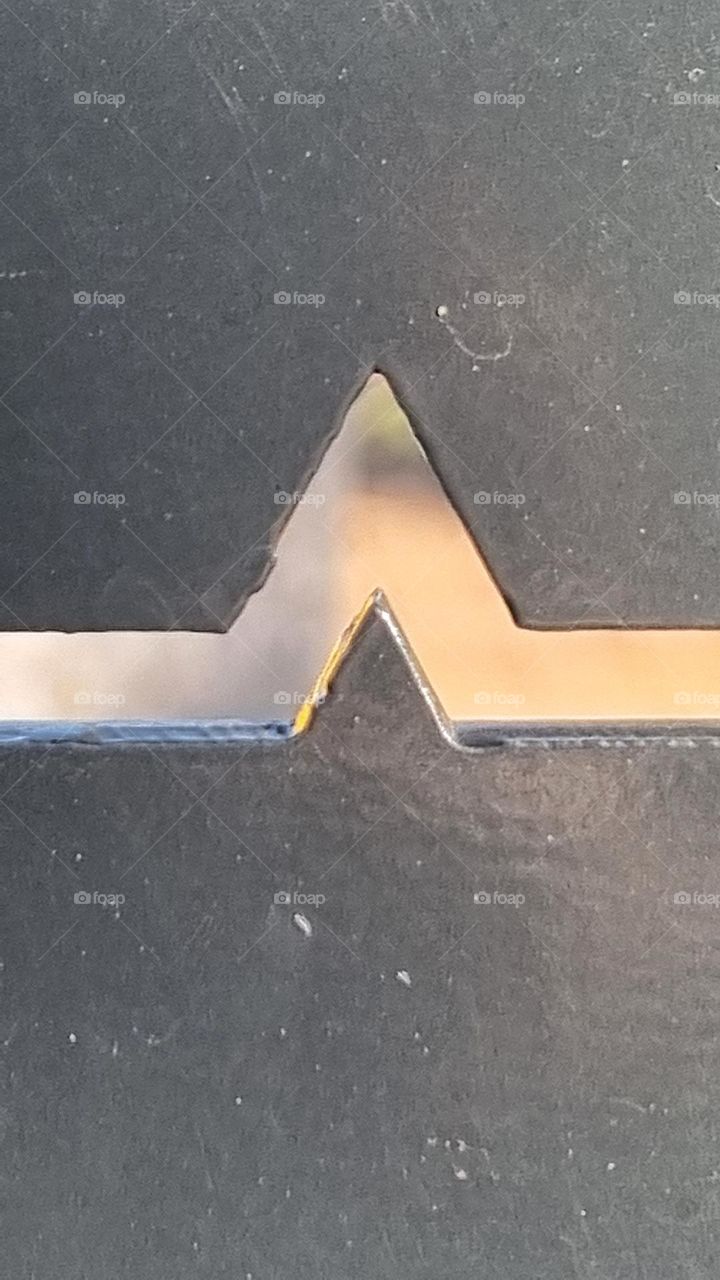 triangle cut into metal