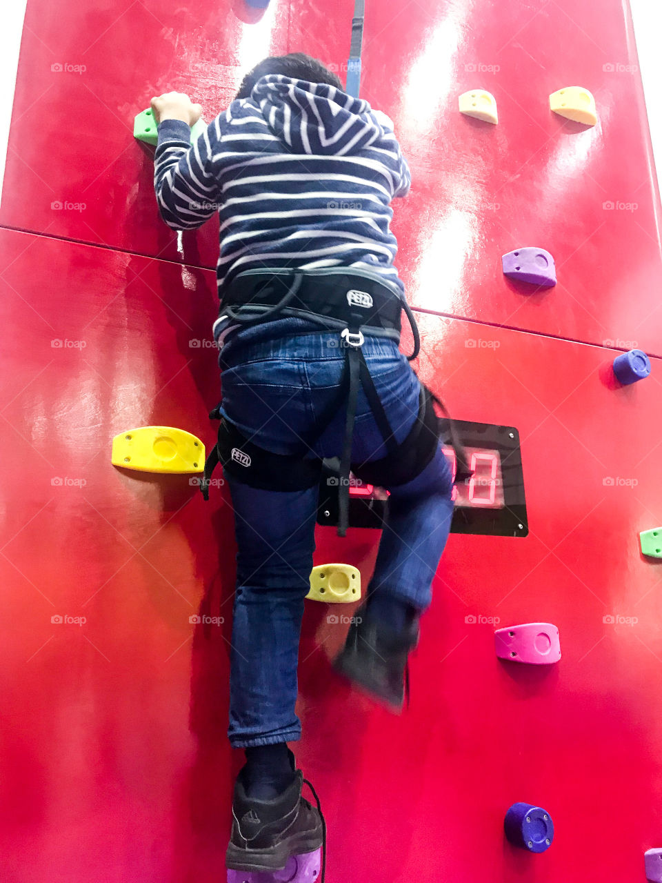 Kid climbing wall holds