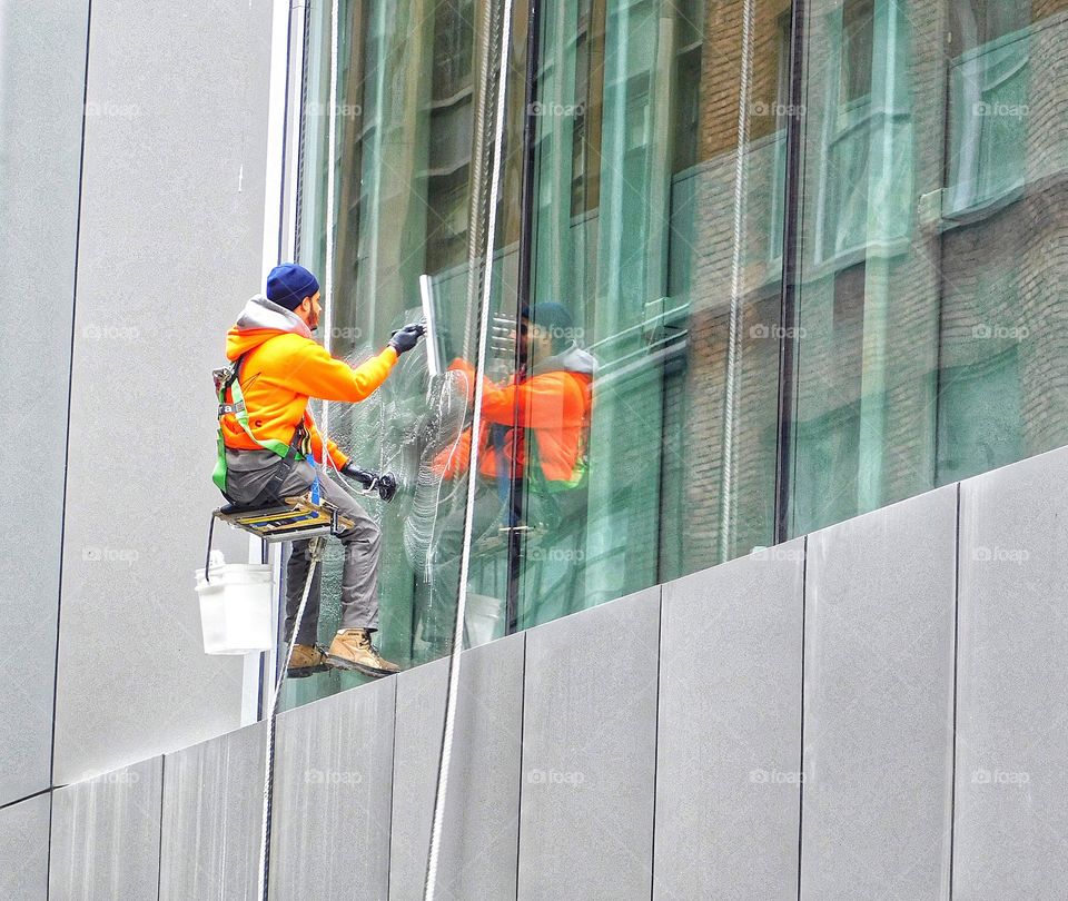 Cute guy cleaning windows in Midtown Manhattan 