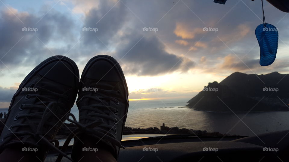 Feet up, sunset over Chapman’s Peak, Cape Town 
