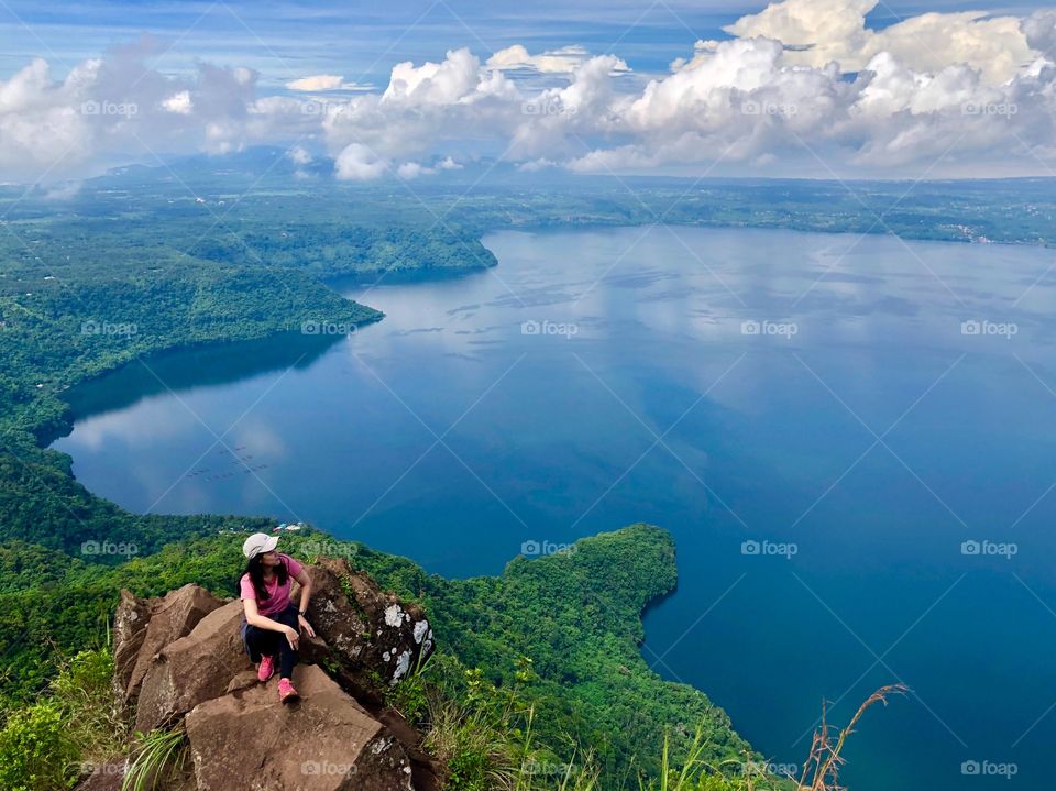 Woman on the mountain summit enjoying the beautiful view